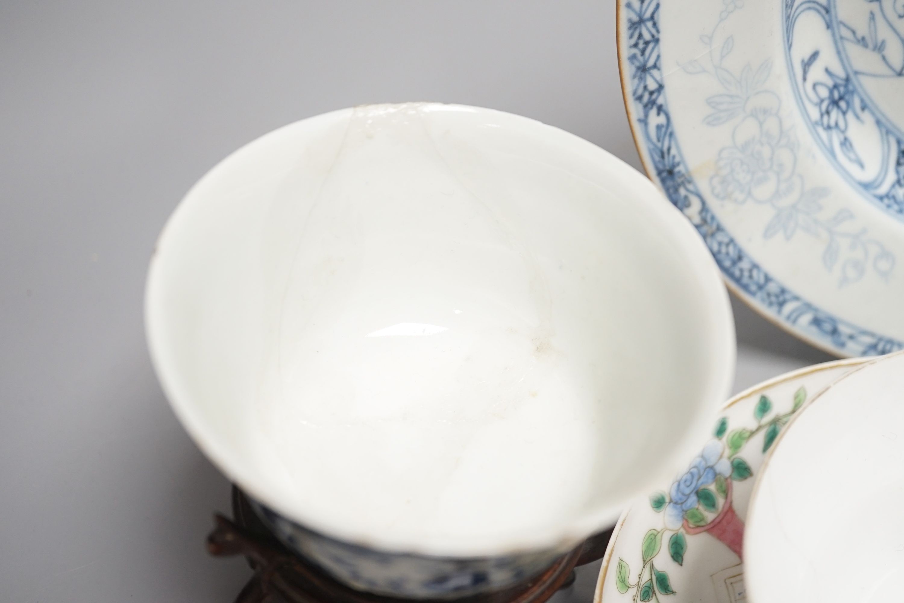 A 19th century Chinese famille rose bowl and saucer, a blue and white tea bowl on stand, a hardstone carving and three 18th century blue and white plates